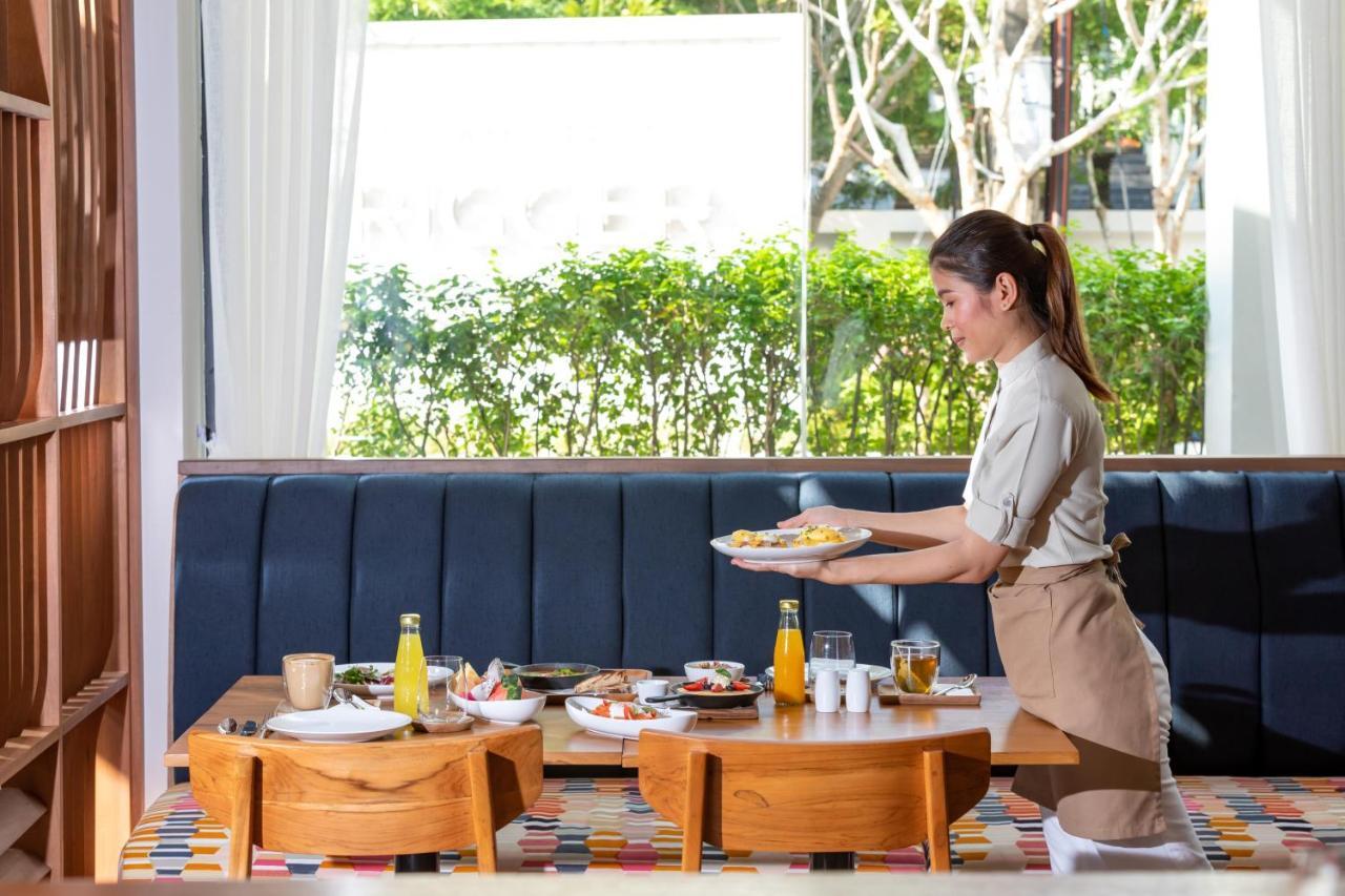 Outrigger Surin Beach Resort - Sha Extra Plus Zewnętrze zdjęcie A Thai waitress serving food